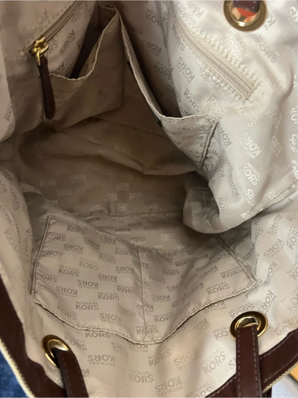 Michael Kors Jet Set tote features monogram canvas, contrasting leather straps